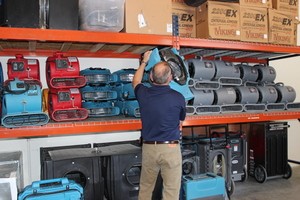Water Damage Restoration Technician Prepping Air Movers