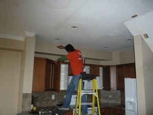 911 Restoration Longview technician inspecting ceiling 