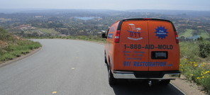 Water and Mold Damage Restoration Van Navigating To Job Location