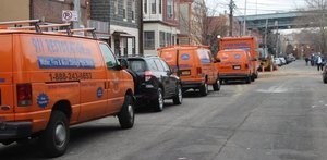 Water and Mold Damage Restoration Vehicles At Urban Job Location